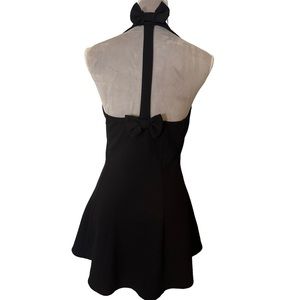 Black halter A line top with bow detail in back. Hi low hem line. Unique. Size L